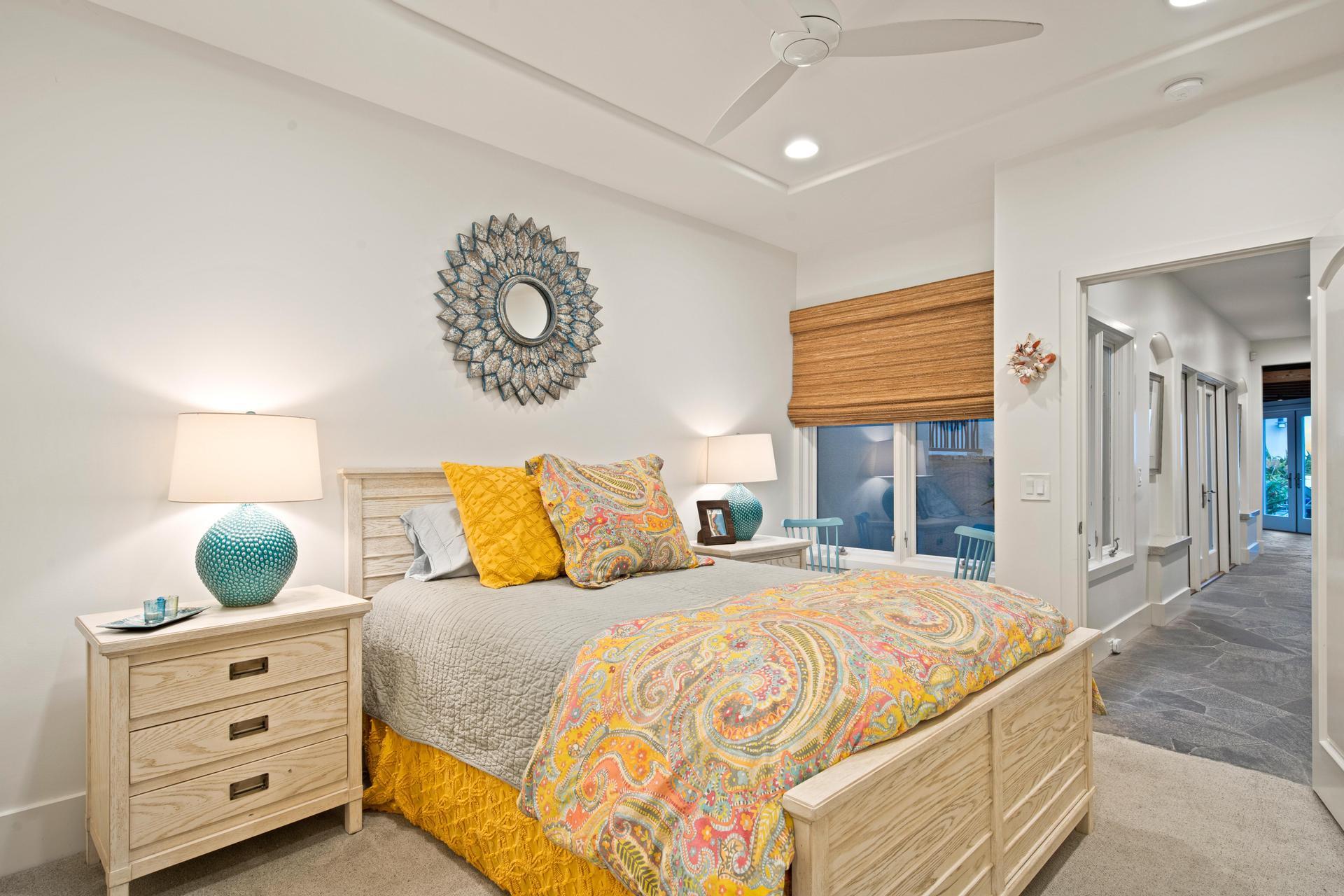 Bedroom with colorful coastal bedding and seating area