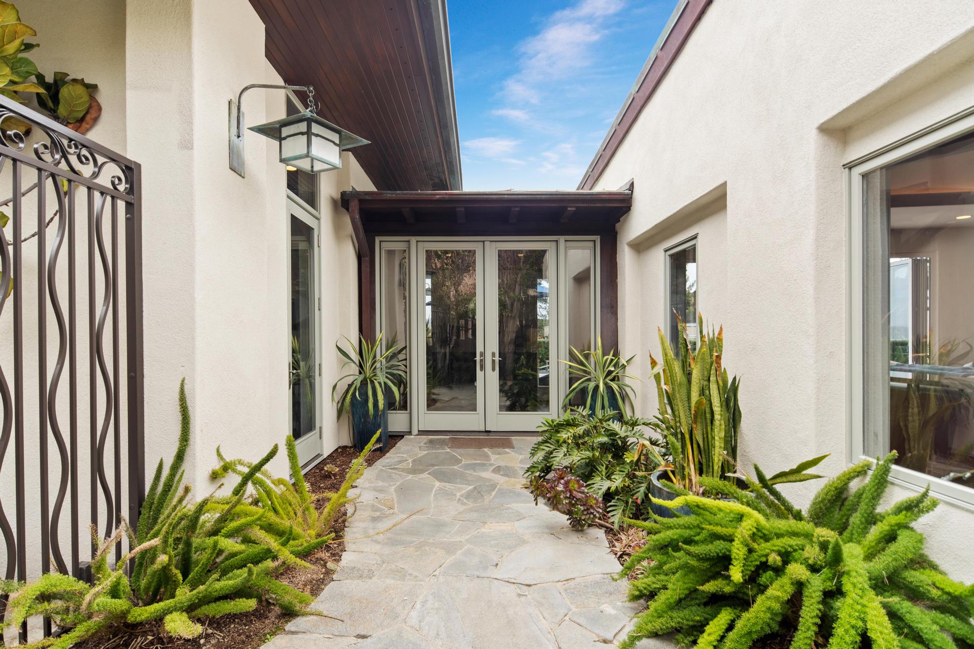 Landscaped entry courtyard at Casa de Costa Paseo